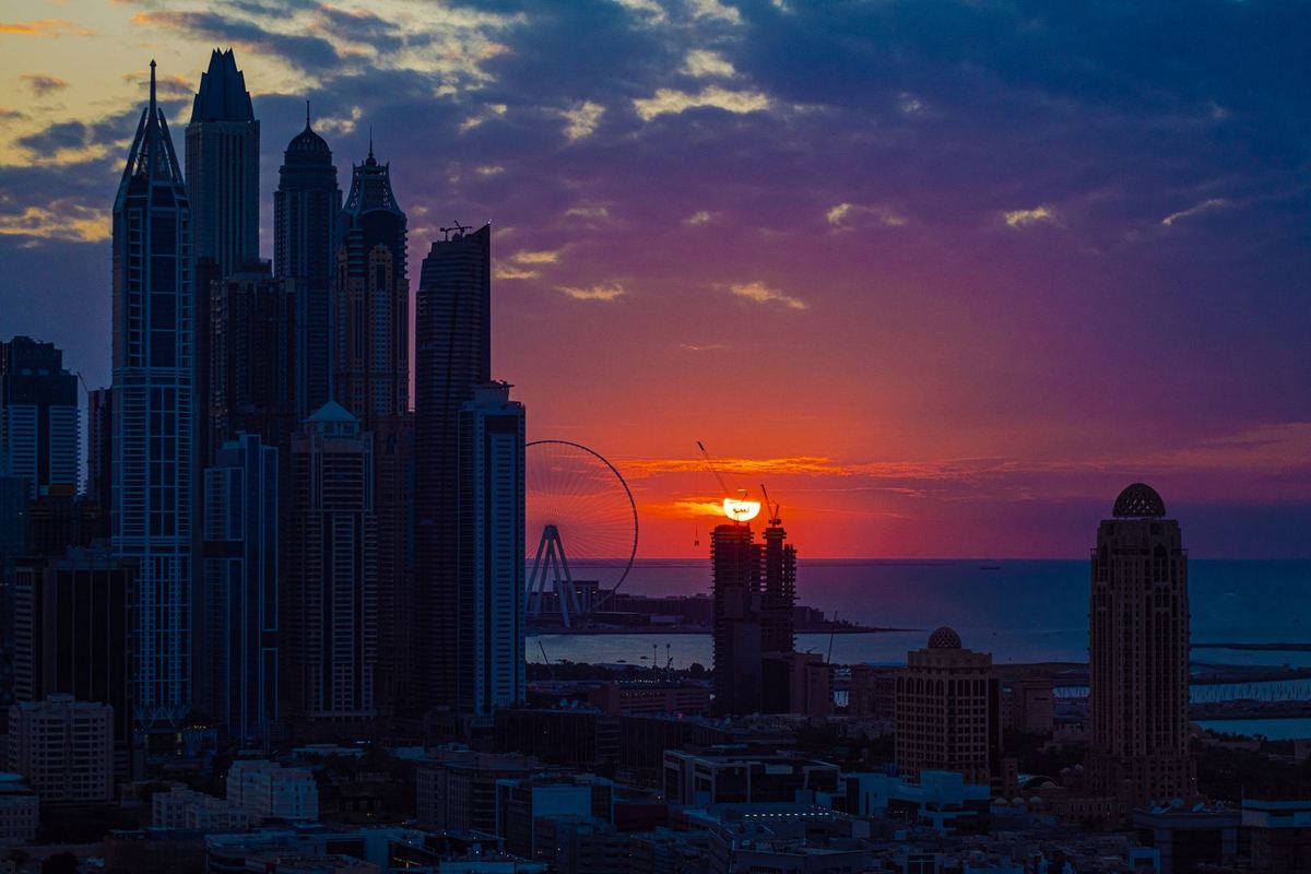 Dubai skyline silhouetted at sunset
